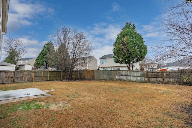 view of yard with a residential view and a fenced backyard