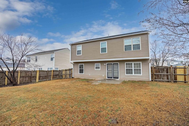 rear view of house featuring a fenced backyard, a patio, and a lawn