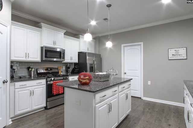 kitchen with dark wood-style floors, stainless steel appliances, backsplash, white cabinets, and a kitchen island