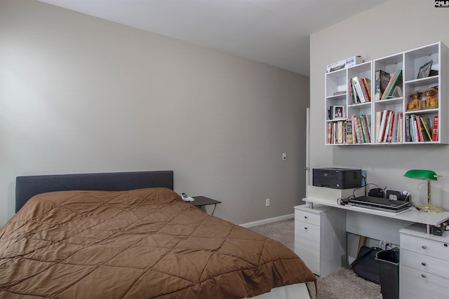 bedroom featuring light carpet and baseboards