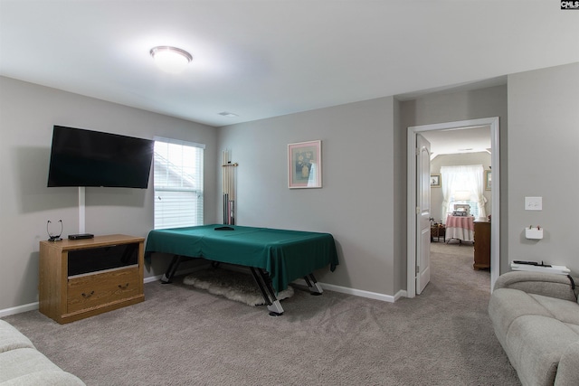 bedroom featuring light carpet and baseboards