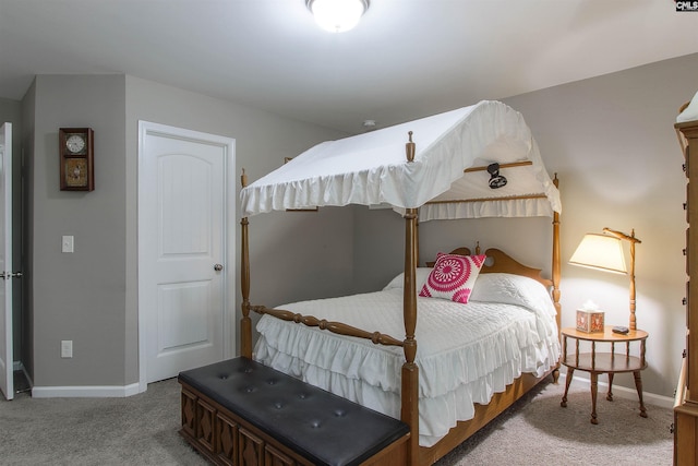 carpeted bedroom featuring baseboards