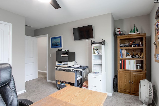 office area with visible vents, baseboards, and light colored carpet