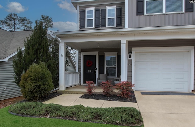 property entrance featuring covered porch and board and batten siding