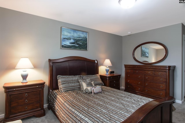 bedroom featuring light carpet and baseboards