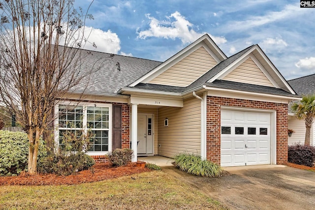 view of front facade with a garage, driveway, brick siding, and a shingled roof