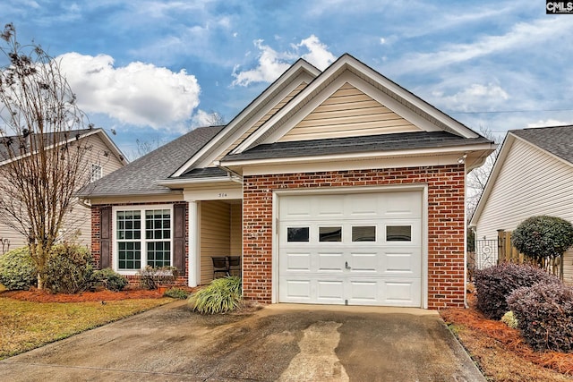 view of front facade with a shingled roof, brick siding, driveway, and an attached garage