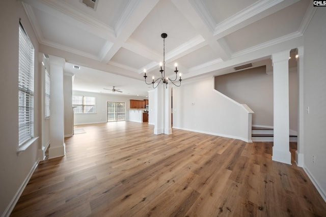 unfurnished dining area featuring decorative columns, visible vents, coffered ceiling, and wood finished floors