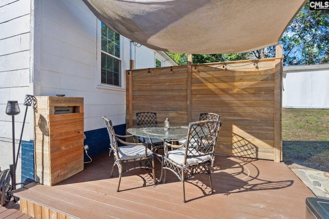 view of patio / terrace featuring a wooden deck and outdoor dining space