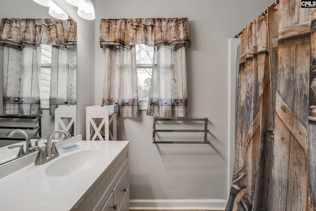 bathroom featuring vanity and baseboards