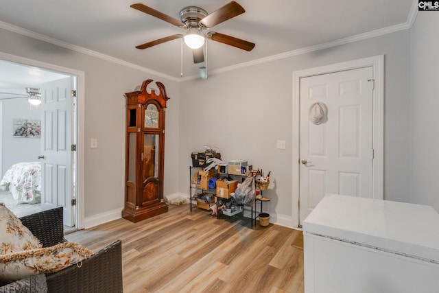 entrance foyer featuring light wood-type flooring, ceiling fan, baseboards, and crown molding