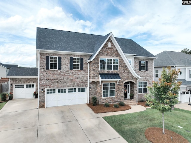 craftsman-style home featuring a shingled roof, brick siding, driveway, and a front lawn