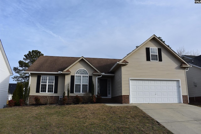 view of front facade featuring driveway, brick siding, and a front yard