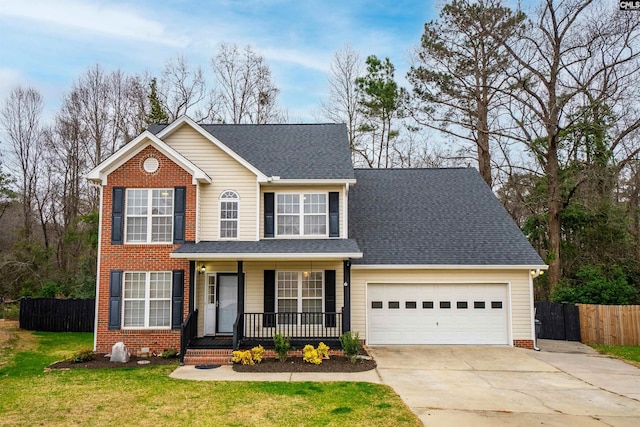 traditional home with driveway, a garage, fence, a porch, and a front yard