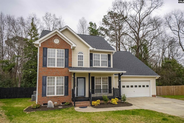 view of front facade with a garage, driveway, fence, a porch, and a front yard