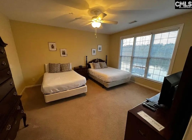 bedroom with carpet floors, baseboards, visible vents, and ceiling fan