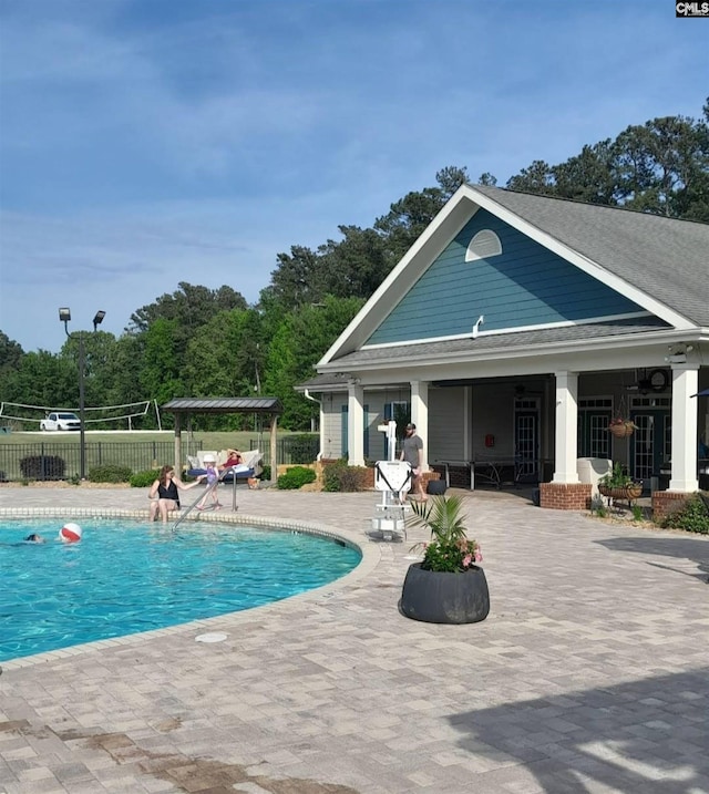 view of swimming pool with a patio area, fence, and a fenced in pool