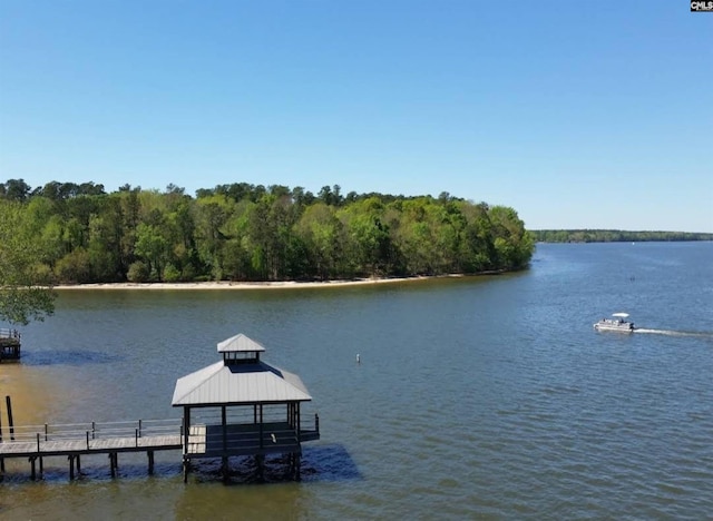 dock area with a water view, a forest view, and a gazebo