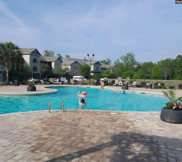 pool featuring a patio and fence