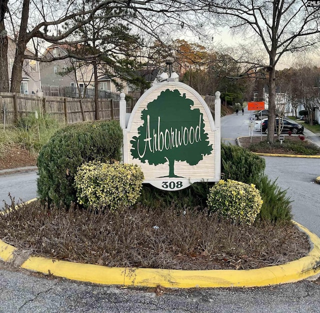 community sign featuring fence