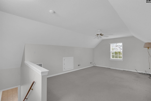 bonus room with visible vents, baseboards, lofted ceiling, carpet, and a textured ceiling