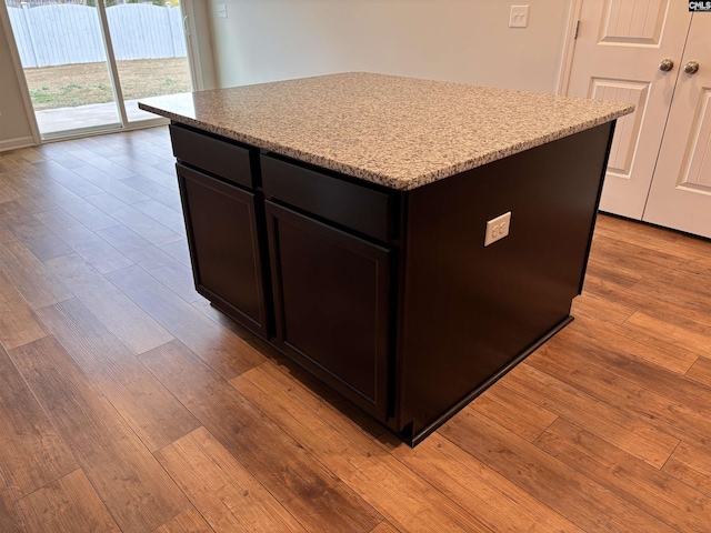 kitchen with light wood finished floors and a center island