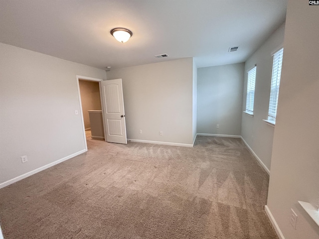 unfurnished bedroom with visible vents and baseboards