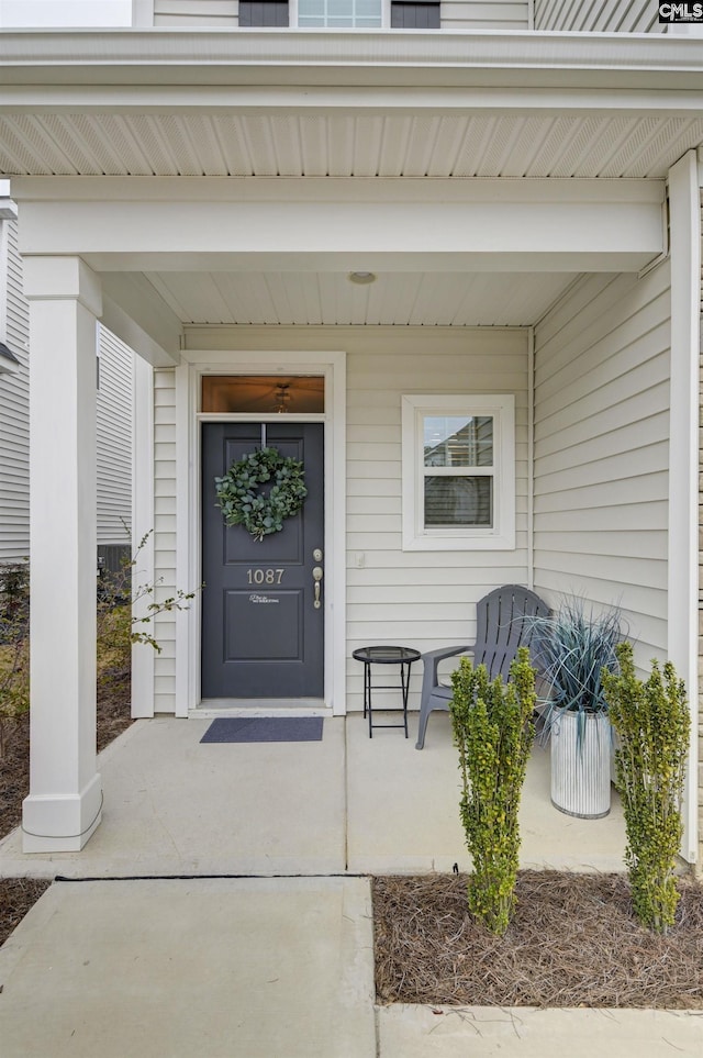 doorway to property featuring covered porch