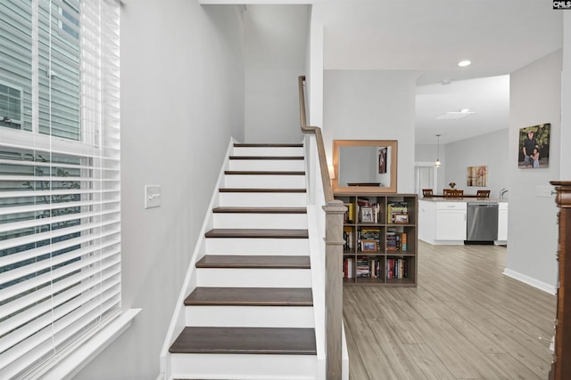 staircase with recessed lighting, baseboards, and wood finished floors