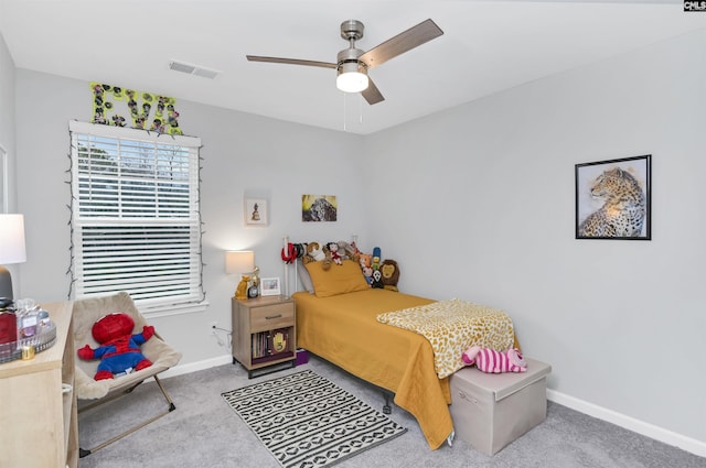 bedroom with light carpet, a ceiling fan, visible vents, and baseboards