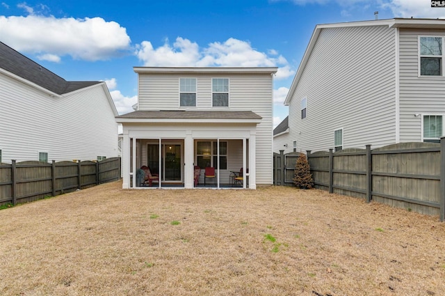 back of house featuring a fenced backyard and a yard