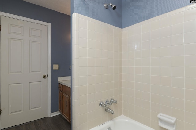 full bath featuring  shower combination, wood finished floors, and vanity