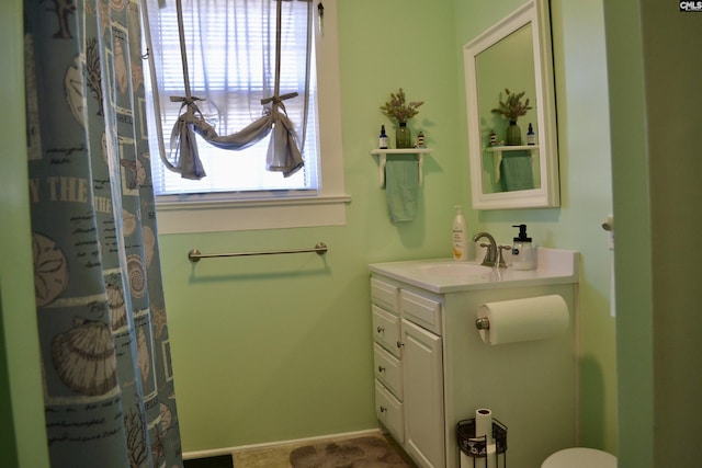 full bathroom with baseboards and vanity