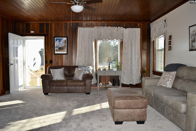 living room featuring plenty of natural light, wood ceiling, and wooden walls