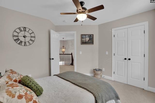 bedroom with a closet, carpet flooring, a ceiling fan, and baseboards