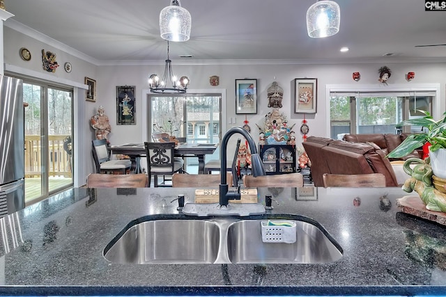 kitchen featuring a wealth of natural light, pendant lighting, and a sink