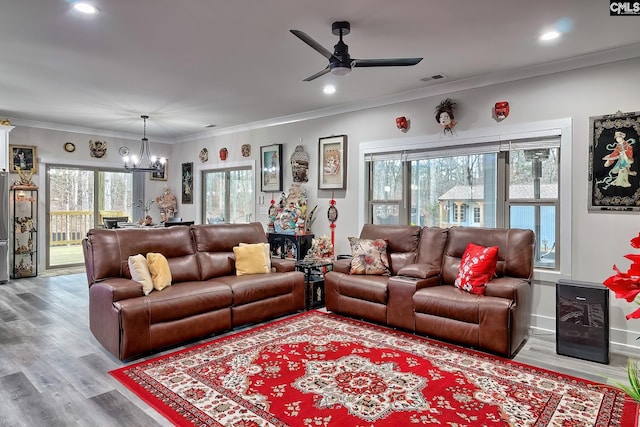 living area with visible vents, ornamental molding, wood finished floors, and recessed lighting