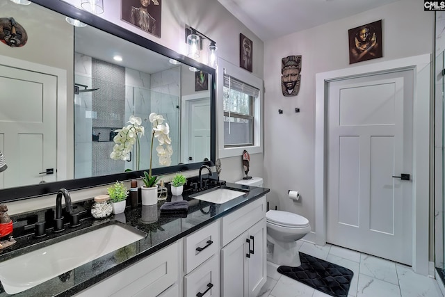 bathroom featuring a stall shower, marble finish floor, a sink, and toilet