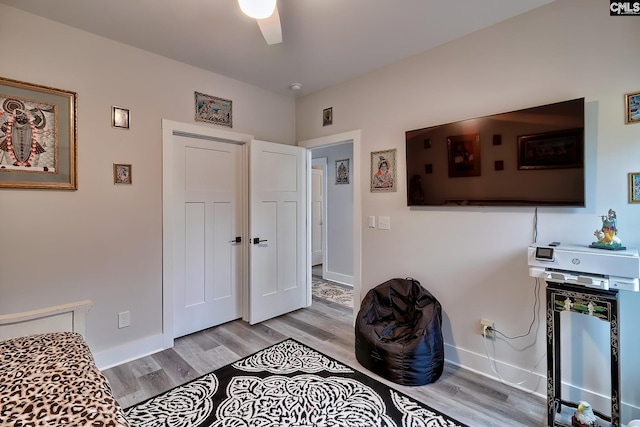 interior space with light wood-type flooring, ceiling fan, and baseboards