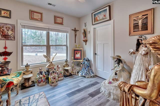 game room featuring light wood-style flooring and visible vents