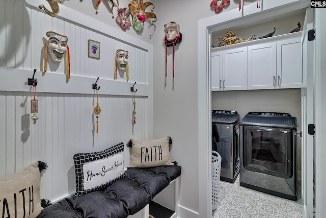 washroom with washer and dryer and cabinet space