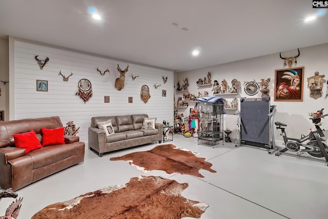 living area with finished concrete floors and recessed lighting