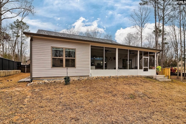 rear view of property featuring a sunroom