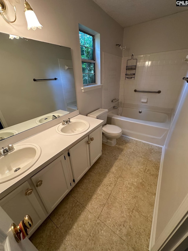 bathroom featuring double vanity, shower / bath combination, a sink, and toilet