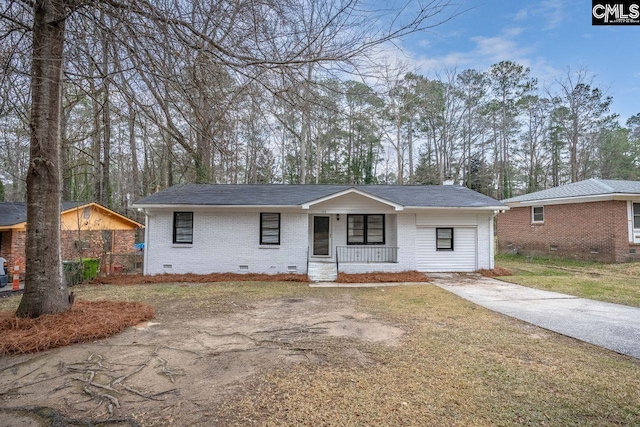 view of front of home featuring driveway, brick siding, crawl space, covered porch, and a front yard