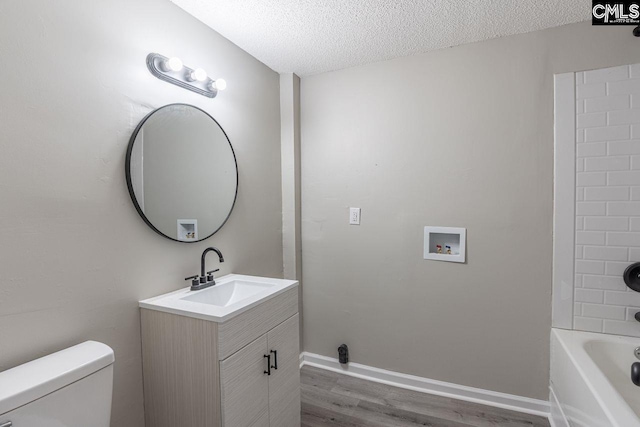 full bath with a textured ceiling, toilet, wood finished floors, vanity, and baseboards