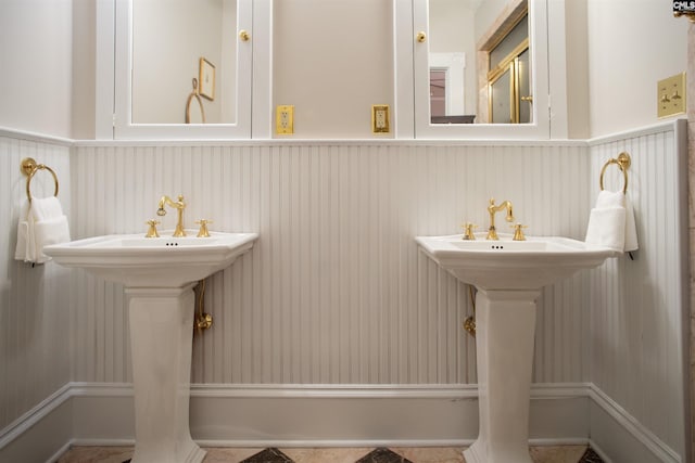 bathroom with a wainscoted wall