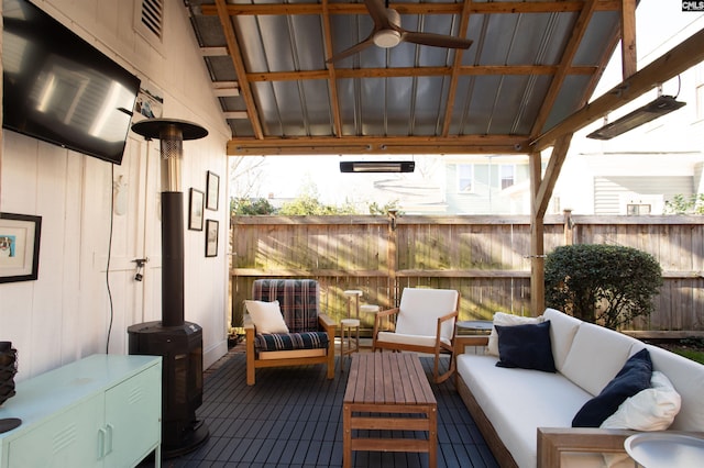 exterior space featuring visible vents, fence, an outdoor living space, and ceiling fan