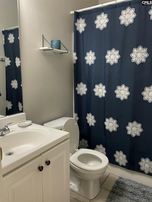 bathroom with vanity, tile patterned flooring, and toilet