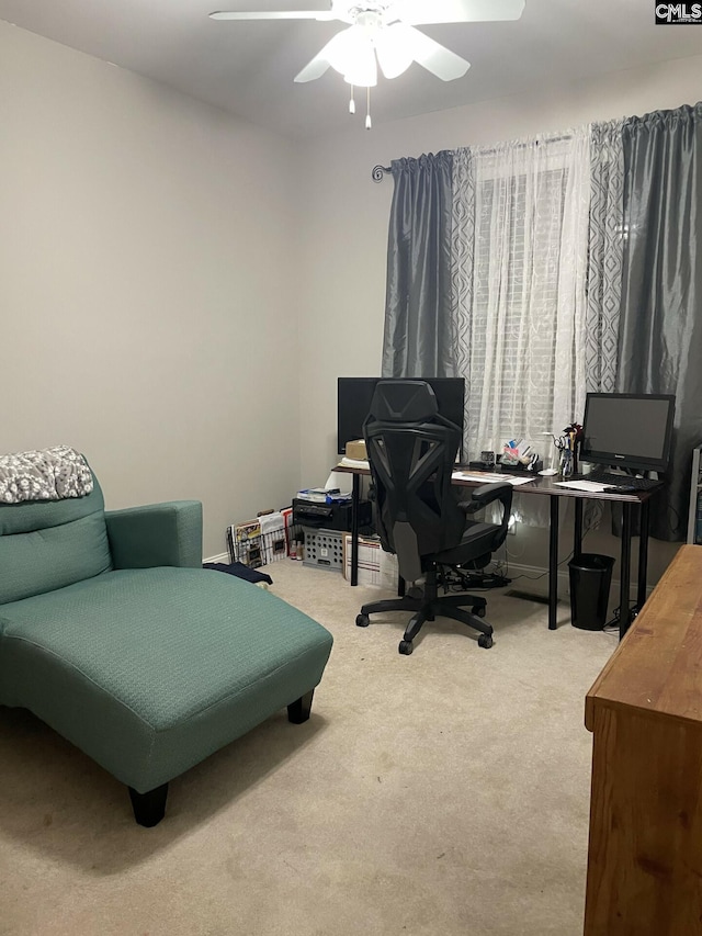 carpeted home office with a ceiling fan